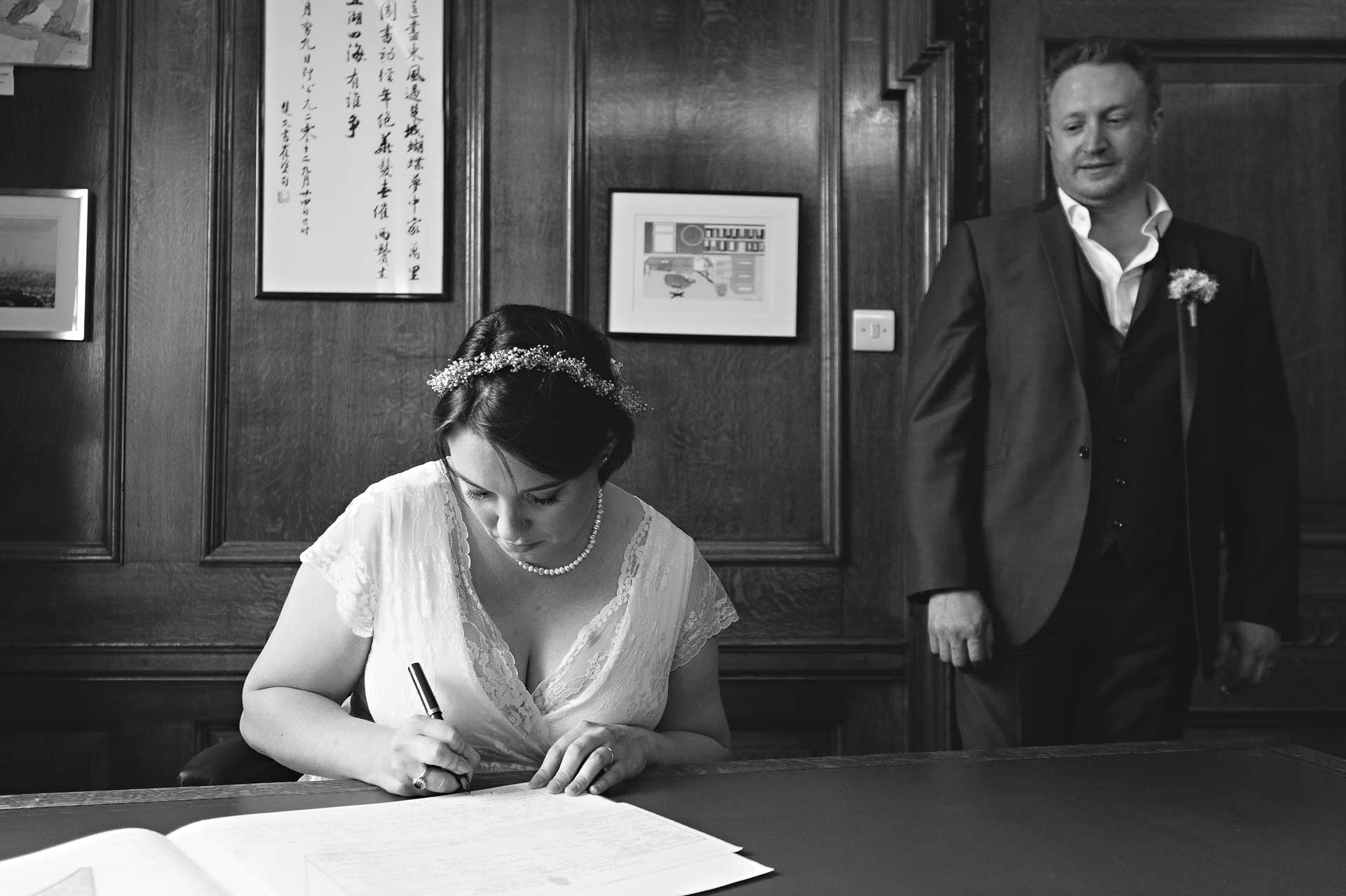 Bride Signing Register in Mayor's Parlour at Islington Town Hall Wedding